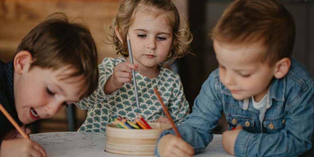 Children play on the Drawin'table, a stimulating piece of Montessori furniture